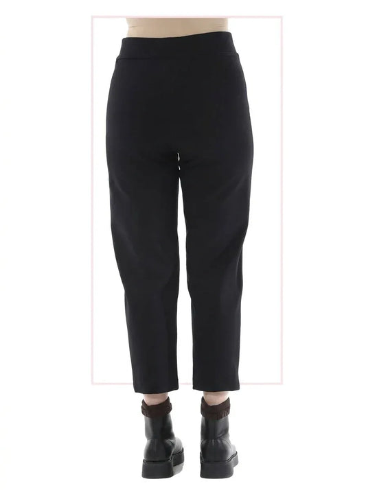 Black pants worn by a person on a white background