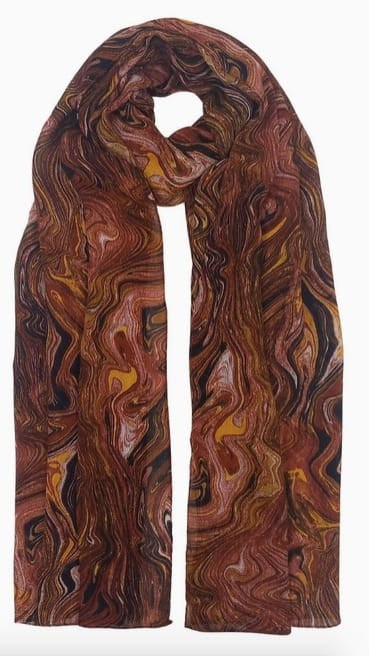 A lightweight scarf with an abstract, swirling wood-grain pattern in shades of brown, rust red, orange, and black, displayed against a plain white background.