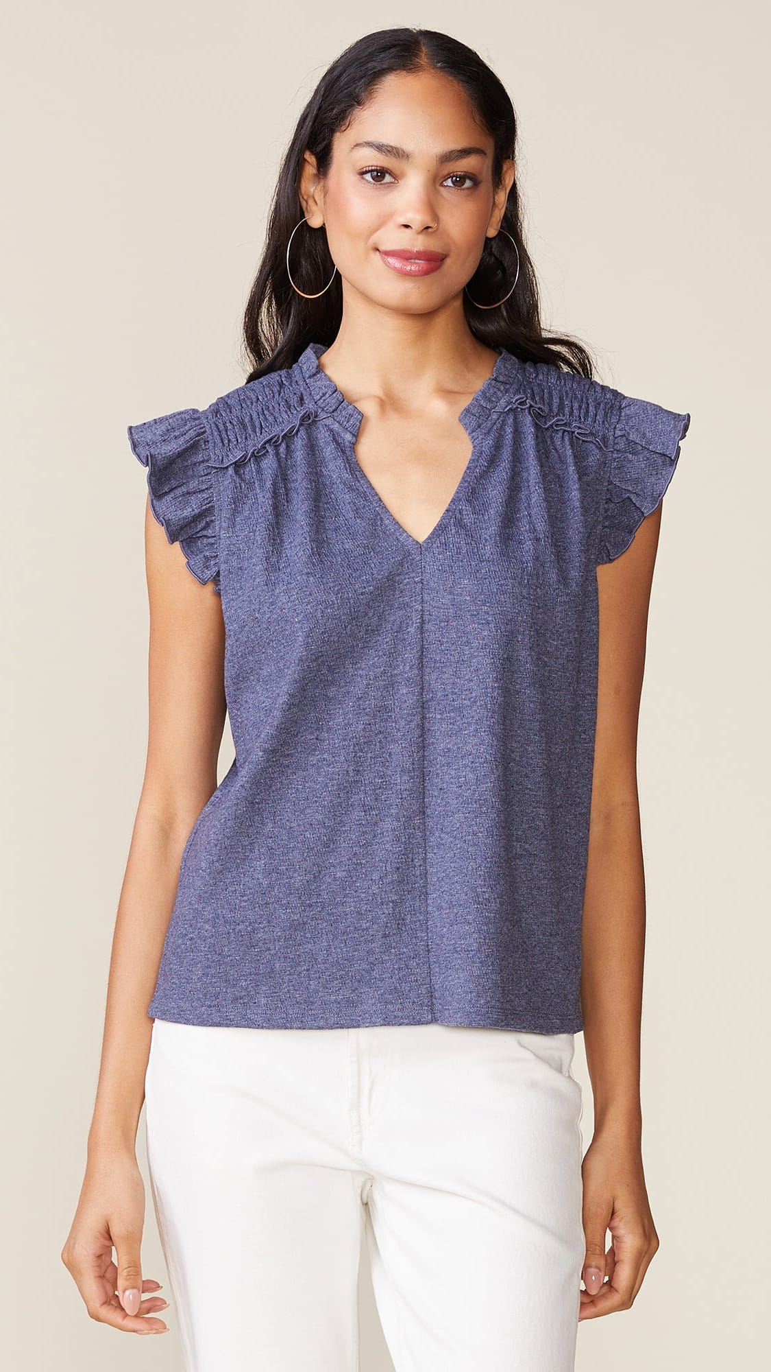 Relaxed, straight style top with notched v-neck with short stand-up collar, smocked detail at the shoulders, relaxed ruffle cap sleeve and center seam detail in front cotton blue