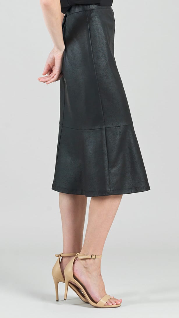 A model is shown from the waist down wearing a black faux-leather midi skirt with a flared hem and beige high-heeled sandals, set against a plain light gray studio background.