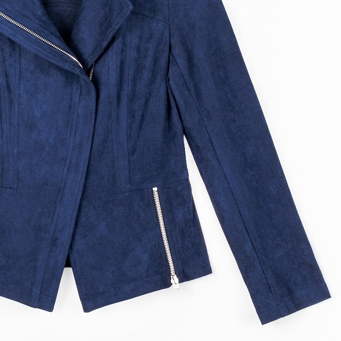 A close-up of a navy blue faux suede jacket with silver zipper details, laid flat against a white background.