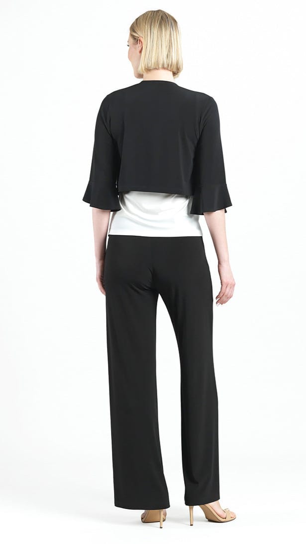 Woman wearing a black jacket and pants with a white top on a white background