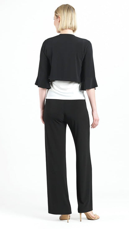 Woman wearing a black jacket and pants with a white top on a white background