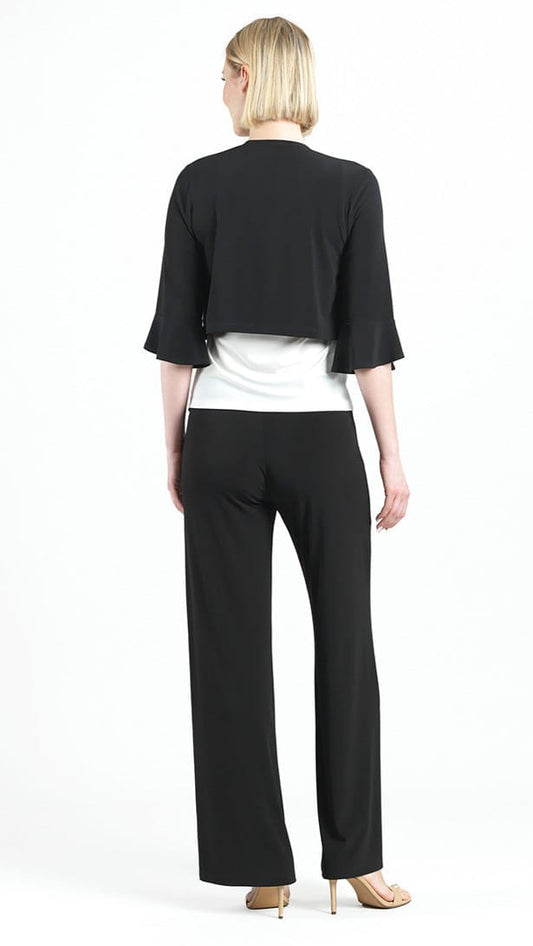 Woman wearing a black jacket and pants with a white top on a white background
