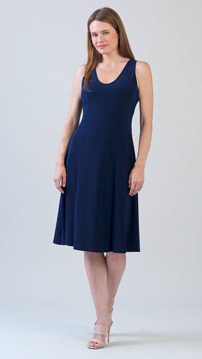 Woman wearing a navy sleeveless dress against a white background