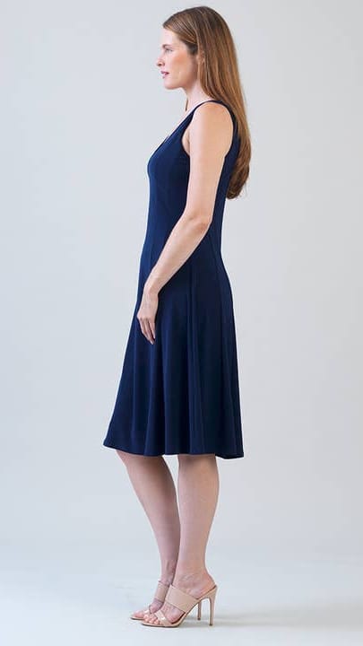 Woman wearing a navy blue dress against a white background