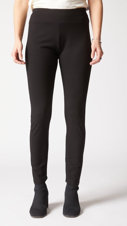 Person wearing black pants on a white background