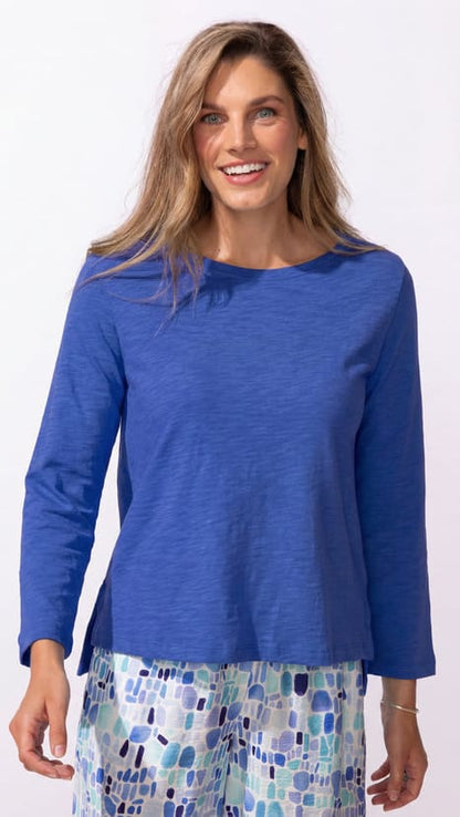 Woman wearing a blue top with a white background