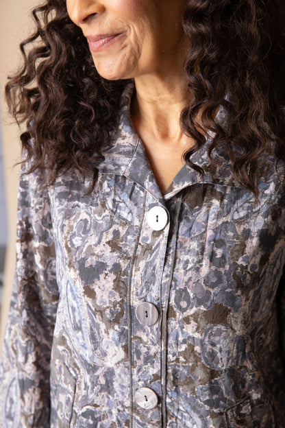 Woman wearing a patterned shirt with buttons