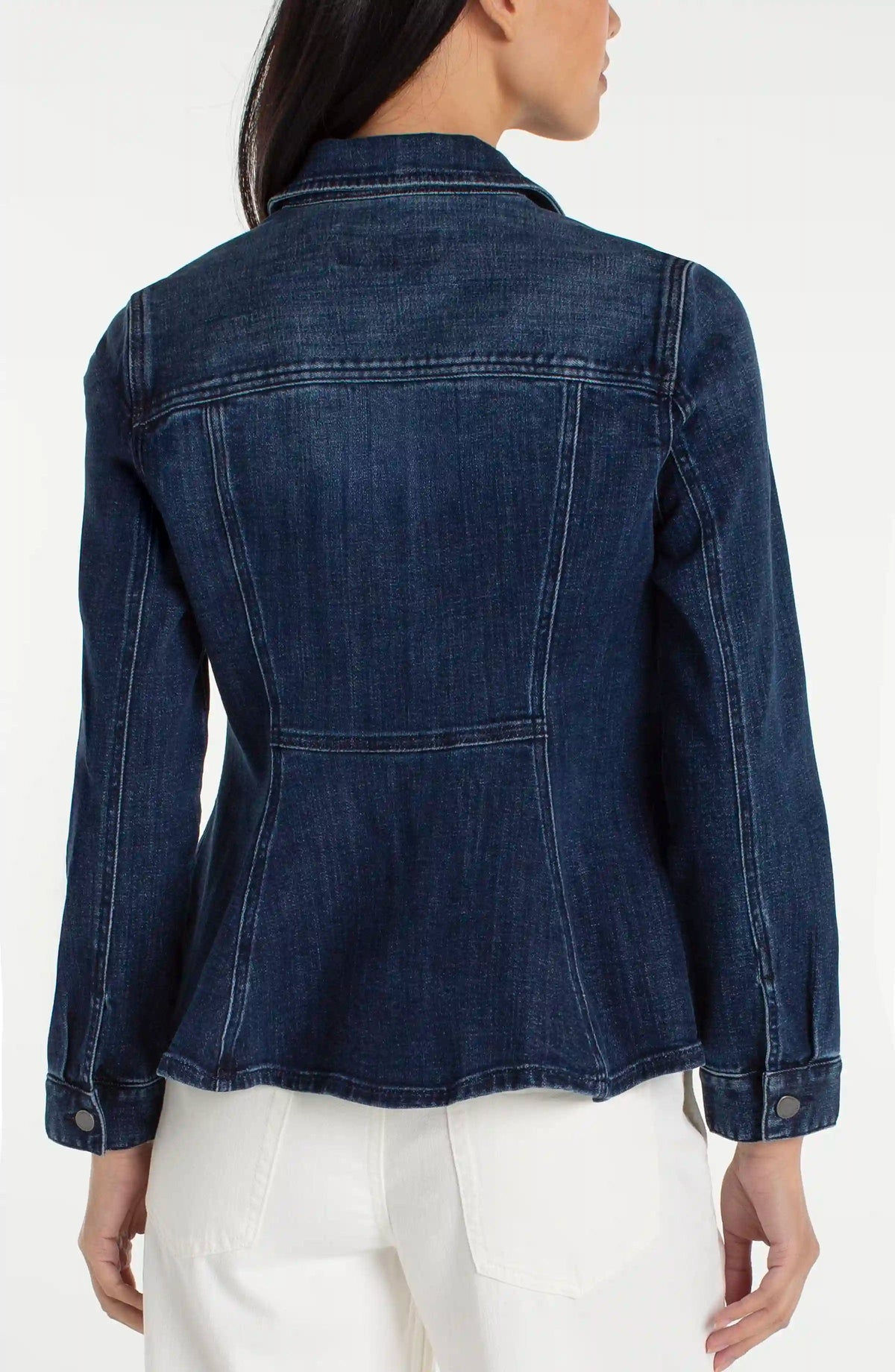 Denim jacket worn by a person on a white background