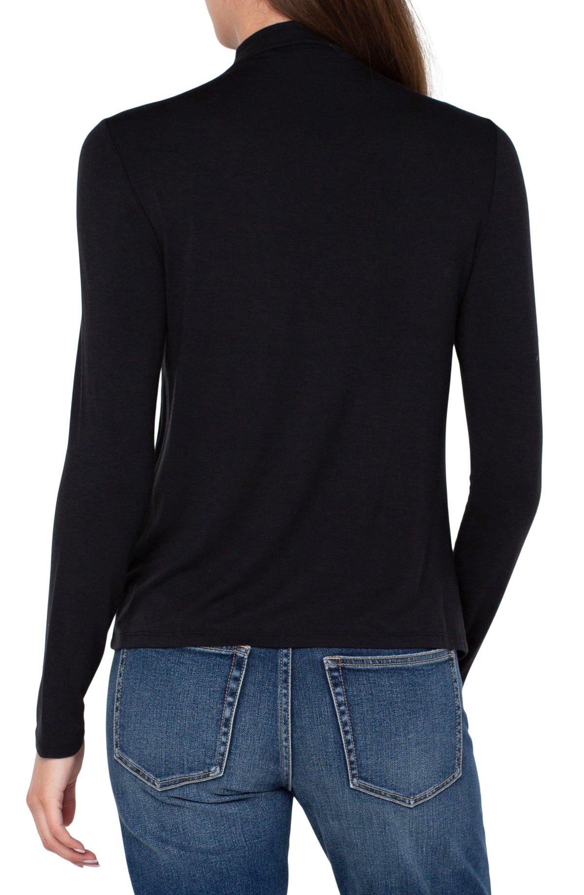 A woman shown from the back wearing a black long-sleeve mock neck top and blue jeans against a plain white background.