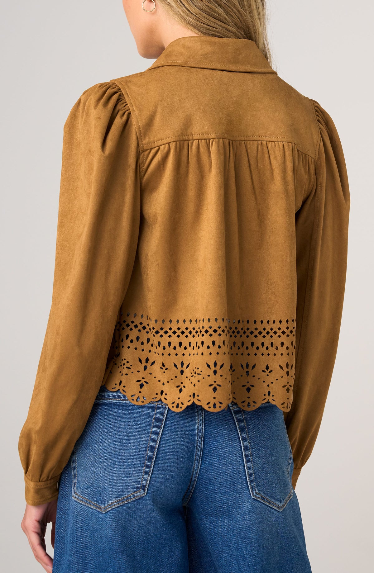Brown suede jacket with lace detailing worn by a person on a plain background