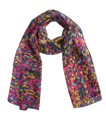 A lightweight silk scarf with a dense, abstract multicolor pattern of pink, yellow, and light blue spots on a dark charcoal gray background, shown against a plain white studio background.