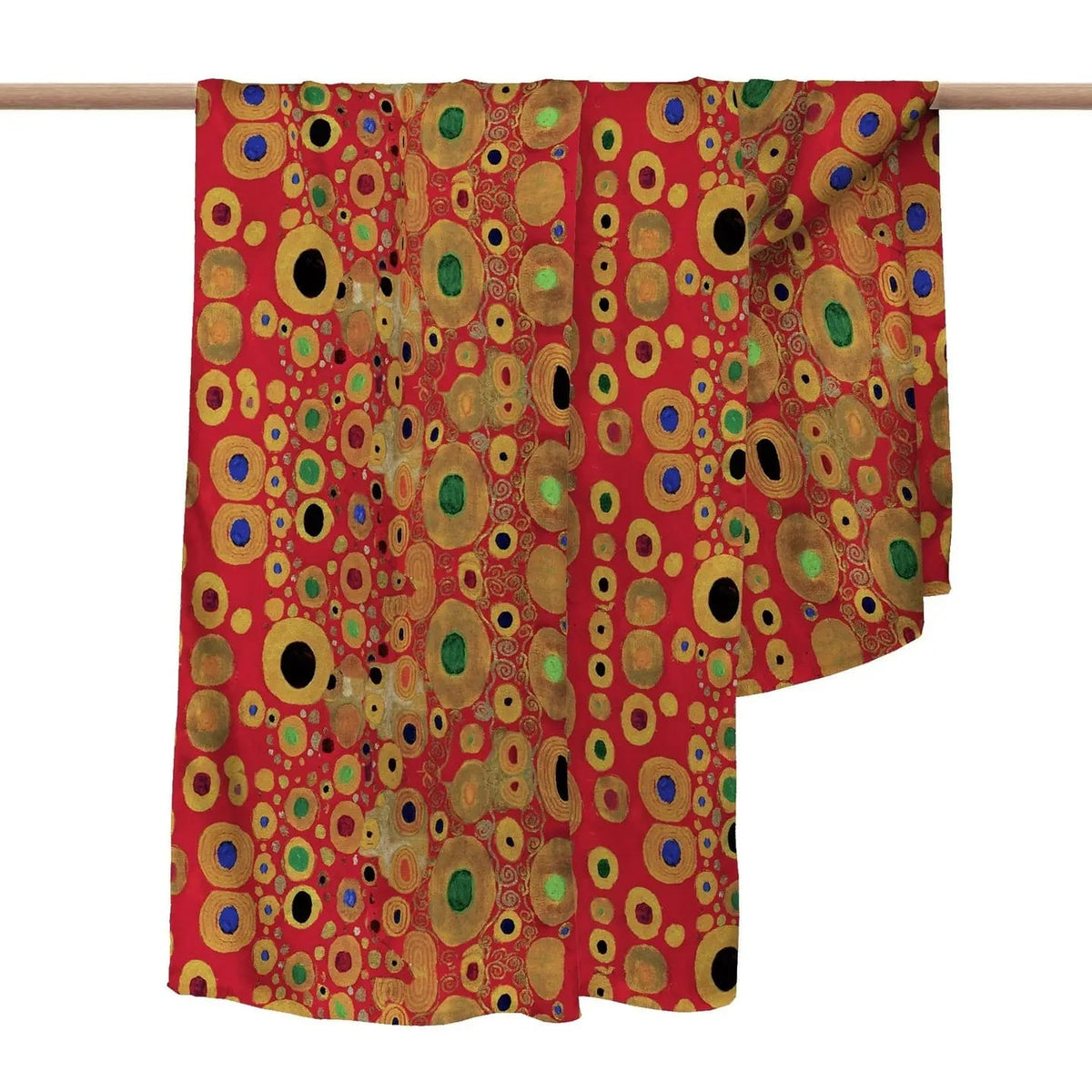 Colorful circular patterned fabric draped over a wooden rod on a white background