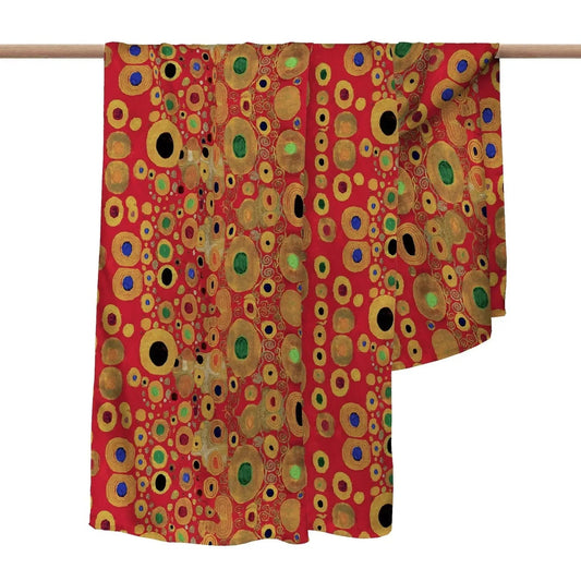 Colorful circular patterned fabric draped over a wooden rod on a white background