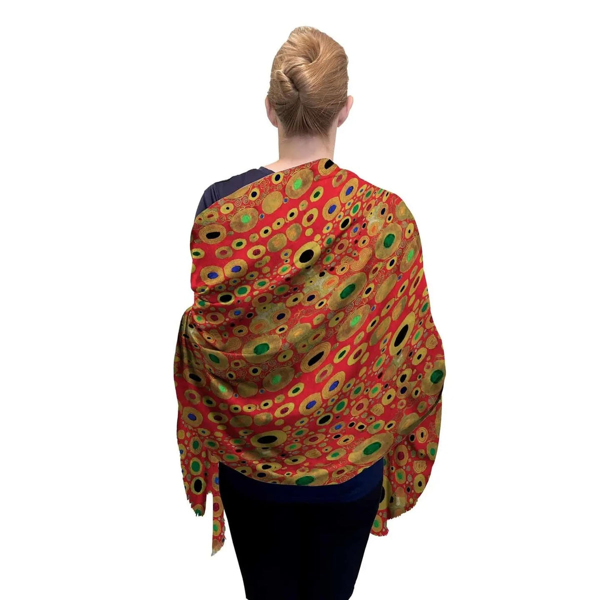 Person wearing a colorful patterned shawl on a white background