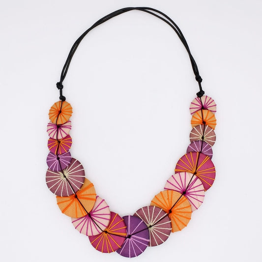 Colorful necklace with circular beads on a white background