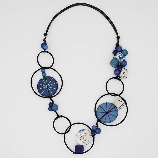 Necklace with blue and black circular beads on a white background