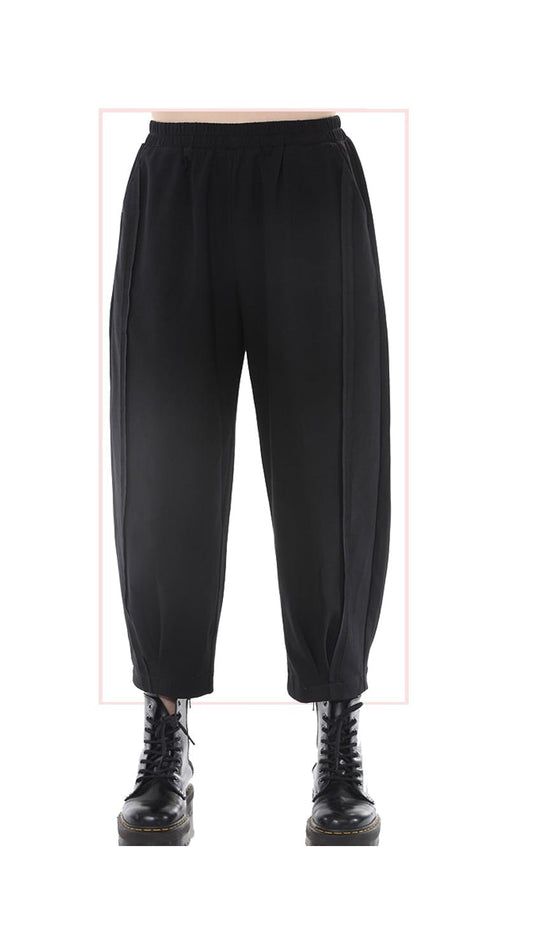 Black barrel leg pants with side seam detailing, shown on a white background with black lace-up boots.