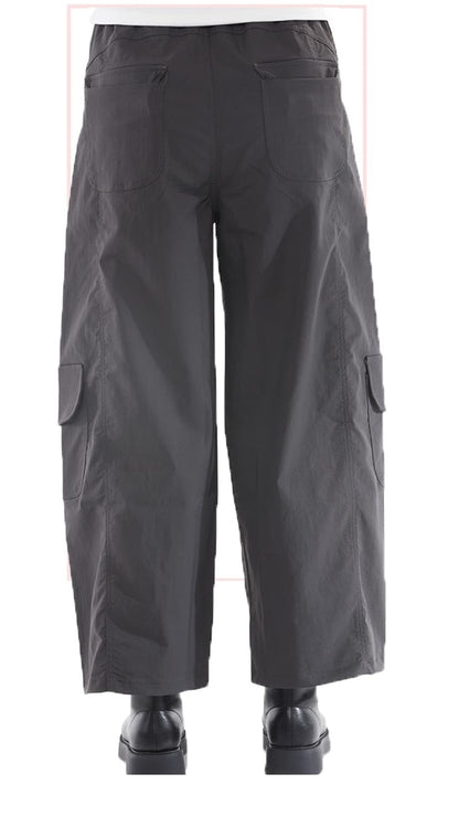 Dark grey wide-leg cargo pants with large side flap pockets, shown from the back on a white background.