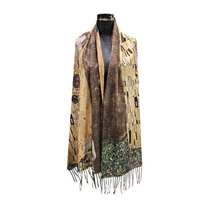 A long open-front shawl draped on a black mannequin torso, featuring an Art Nouveau style print in gold, brown, beige, and green with fringe along the bottom edge, set against a plain white background.